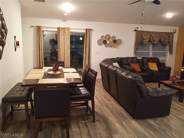 dining room with ceiling fan and light hardwood / wood-style flooring