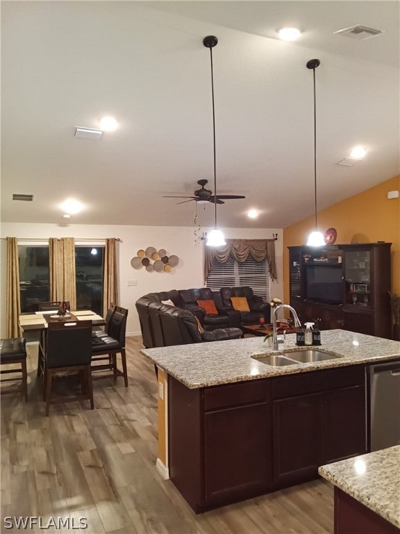 kitchen featuring ceiling fan, sink, dishwasher, hardwood / wood-style flooring, and pendant lighting