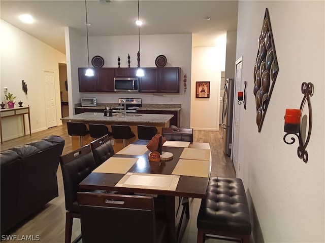 dining area featuring light wood-type flooring and sink