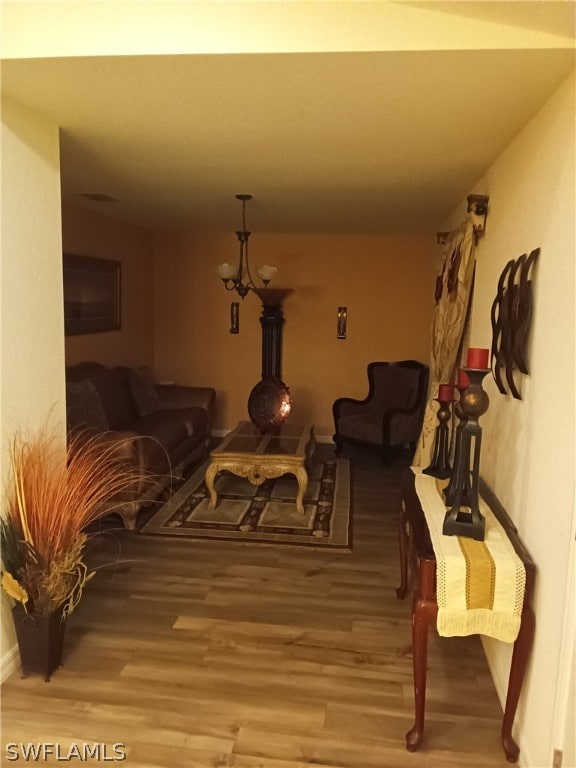 living room featuring a chandelier and dark wood-type flooring