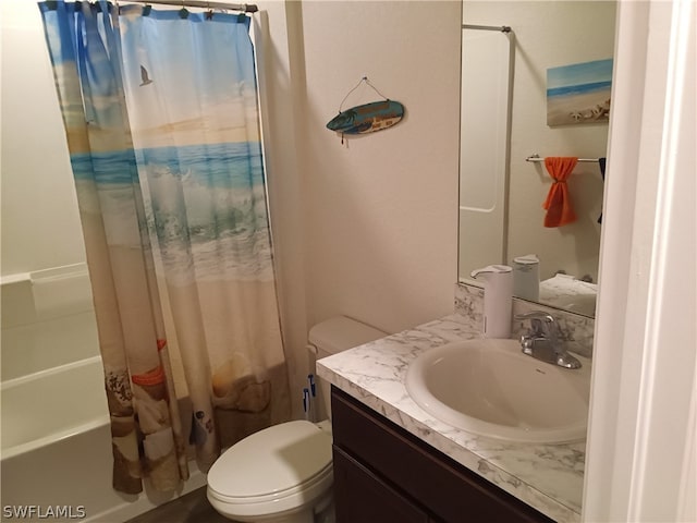 full bathroom featuring toilet, large vanity, and shower / bath combo