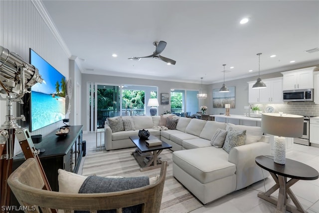 living room featuring ornamental molding, ceiling fan, and light tile floors