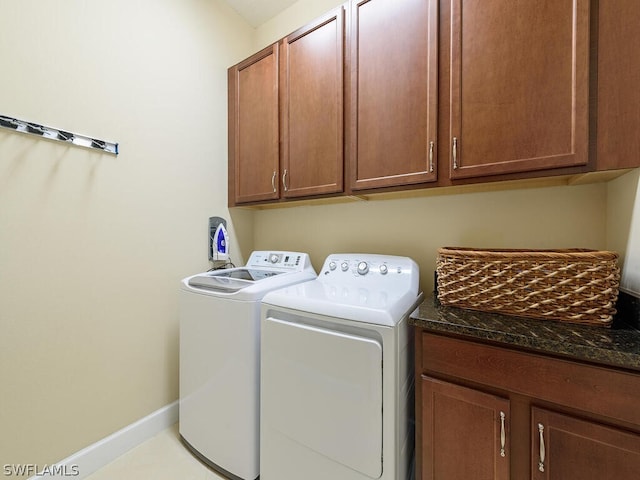 laundry area with cabinets and washing machine and dryer