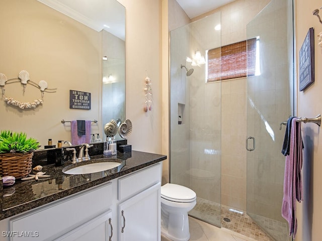 bathroom with a shower with door, vanity, toilet, ornamental molding, and tile patterned floors