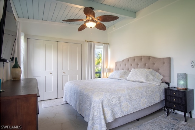 tiled bedroom featuring a closet, wood ceiling, ceiling fan, and lofted ceiling with beams