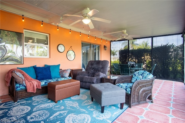 sunroom / solarium featuring track lighting and ceiling fan