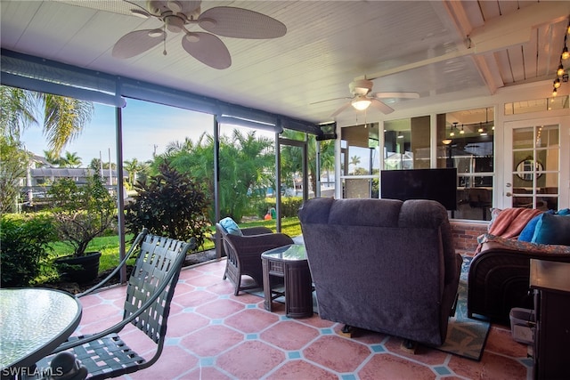 sunroom featuring ceiling fan