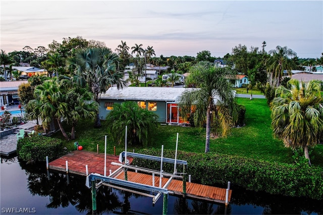 dock area featuring a water view and a yard