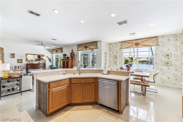 kitchen with light tile patterned floors, sink, hanging light fixtures, a center island with sink, and stainless steel dishwasher