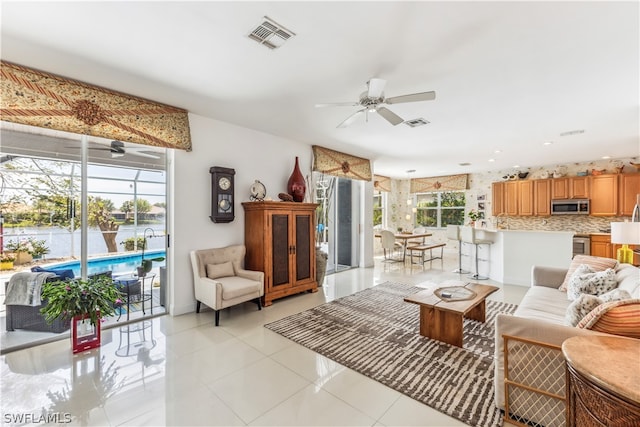 living room with ceiling fan and light tile floors