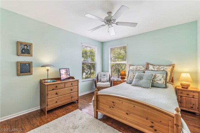 bedroom with dark hardwood / wood-style floors and ceiling fan