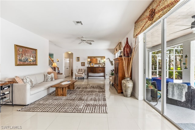 tiled living room featuring ceiling fan