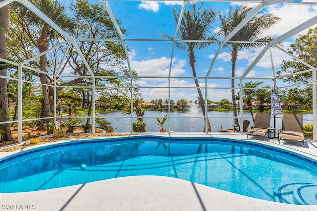 view of swimming pool featuring glass enclosure and a patio