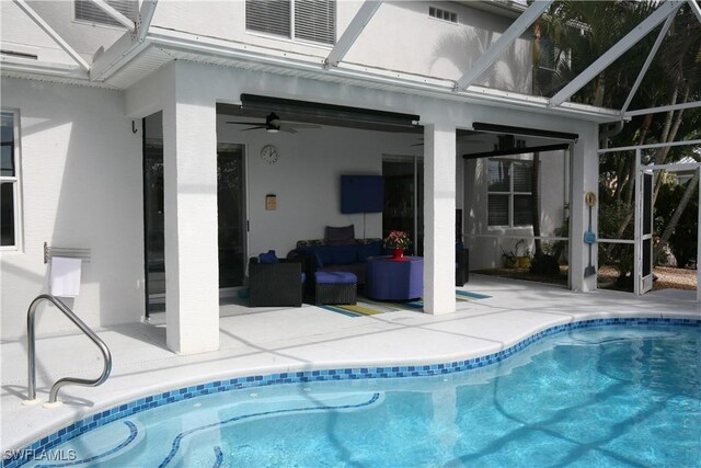 view of pool with ceiling fan, an outdoor hangout area, glass enclosure, and a patio area