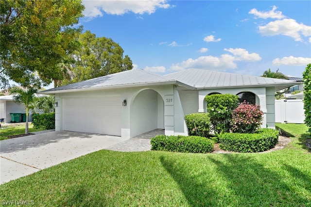 ranch-style home featuring a garage and a front lawn