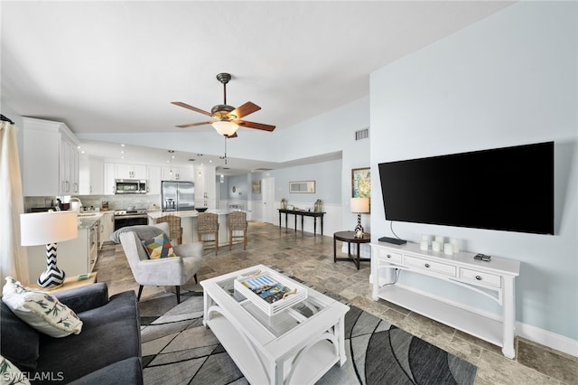 living room featuring ceiling fan and sink