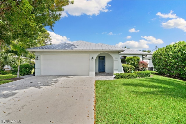 view of front of property with a garage and a front yard