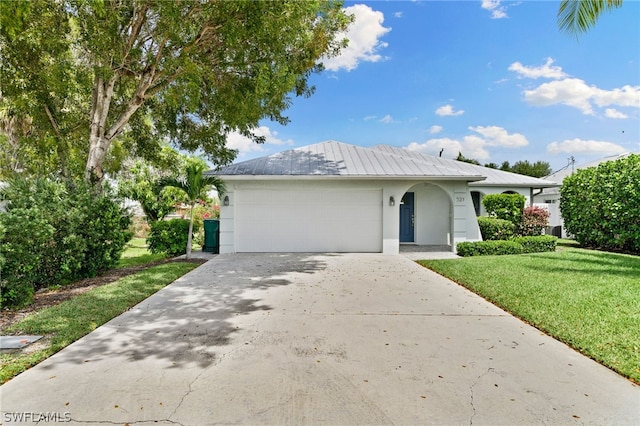 view of front of house with a garage and a front yard