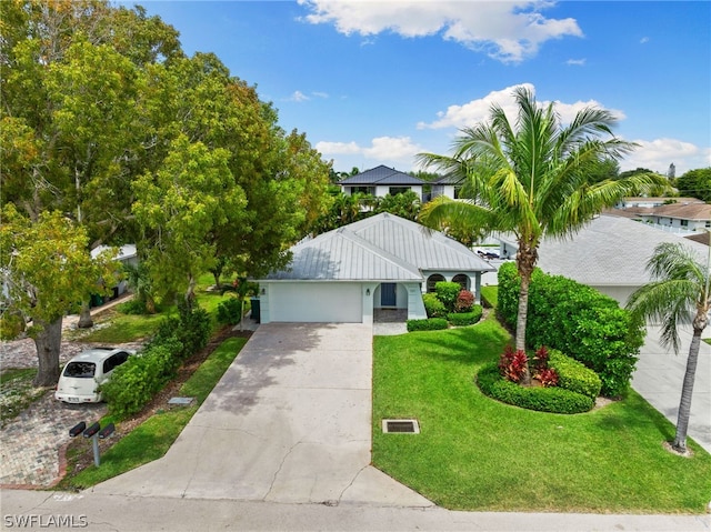 view of front of property featuring a garage and a front yard