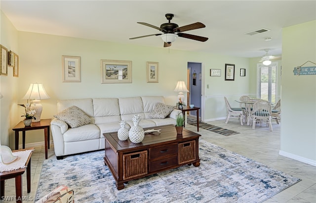 tiled living room featuring ceiling fan