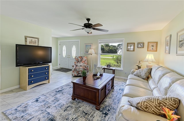 living room with light tile floors and ceiling fan