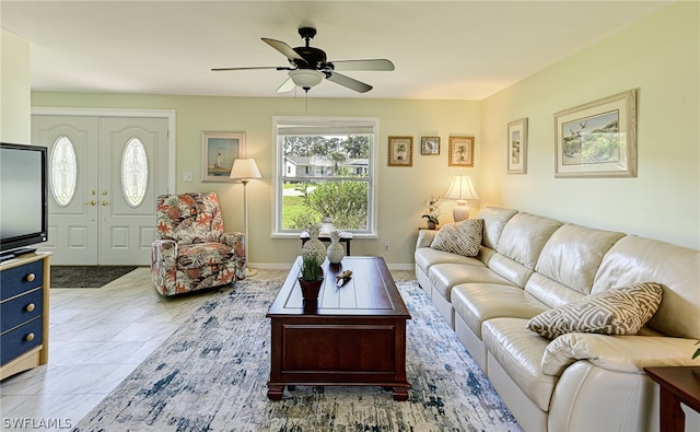 living room with ceiling fan and light tile flooring