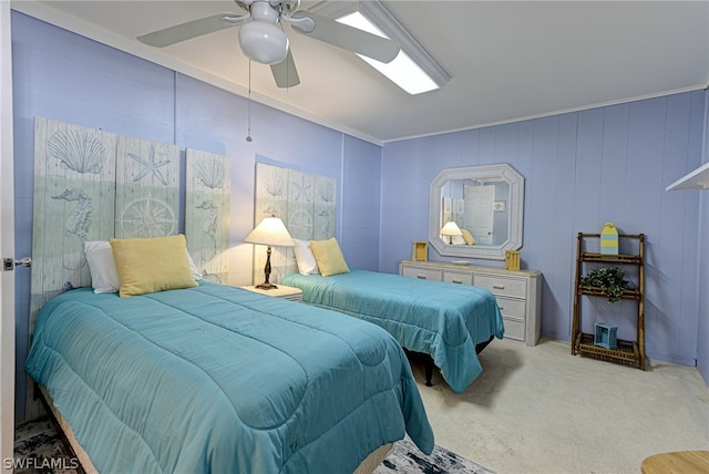 carpeted bedroom featuring ceiling fan and ornamental molding