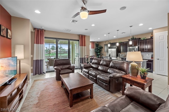 tiled living room featuring ceiling fan