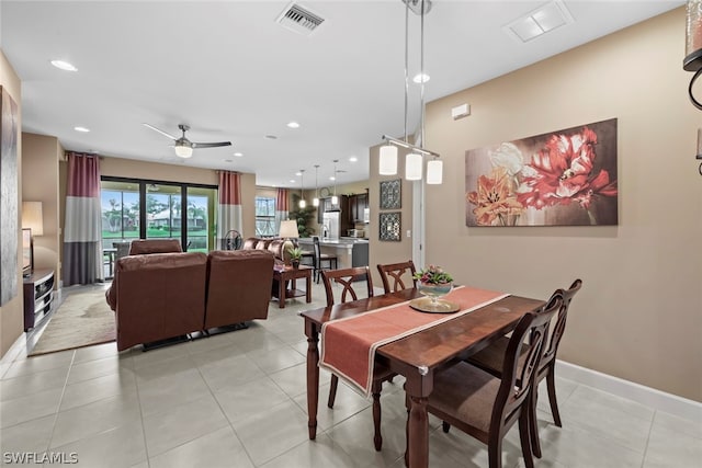 dining area featuring light tile floors and ceiling fan