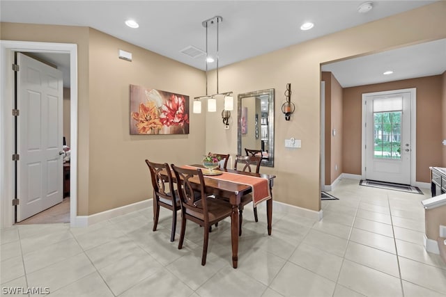 dining area featuring light tile floors