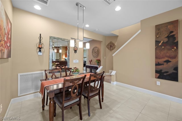 dining area featuring light tile floors