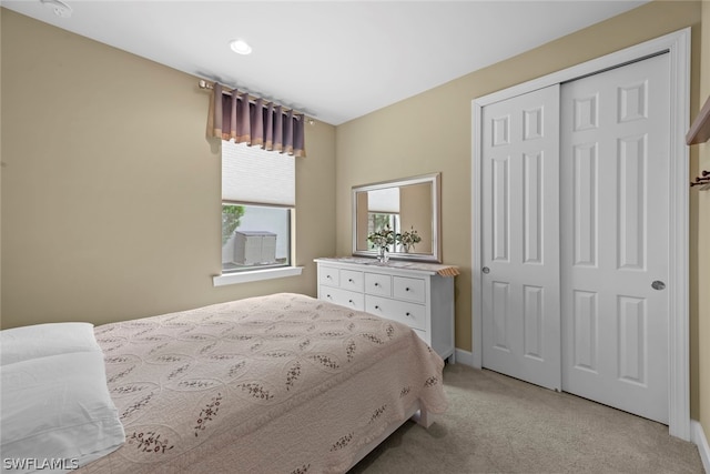 bedroom featuring a closet and light carpet