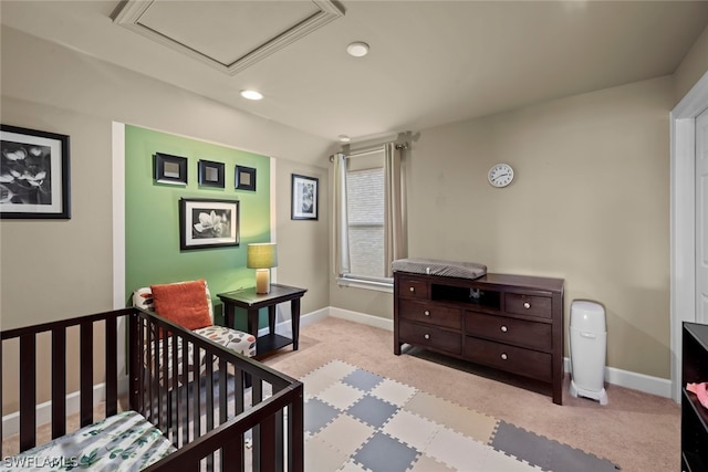 carpeted bedroom featuring a crib