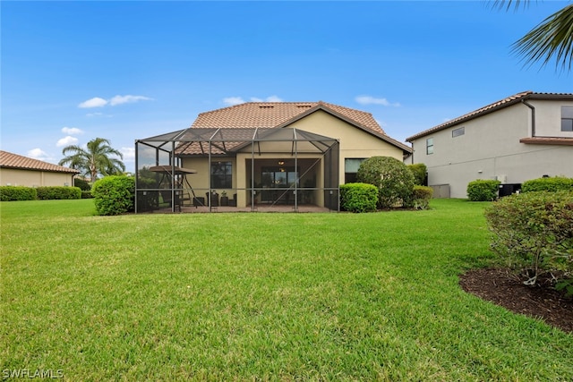 rear view of property with glass enclosure, central AC, and a lawn