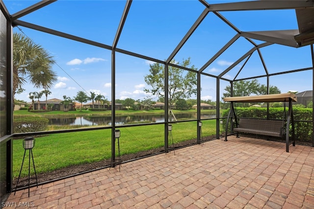 unfurnished sunroom featuring a water view