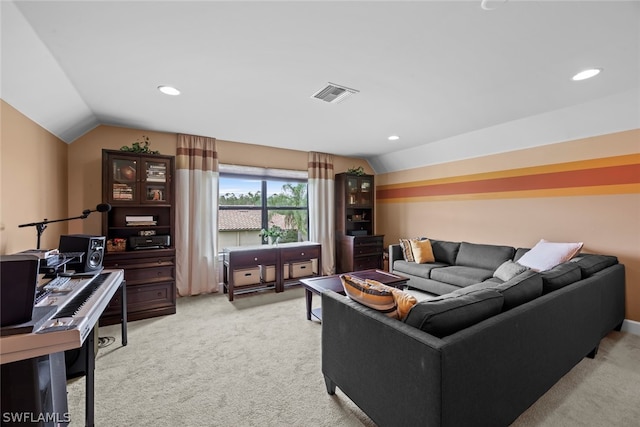 carpeted living room featuring vaulted ceiling