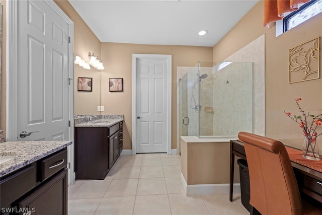 bathroom featuring walk in shower, dual vanity, and tile flooring