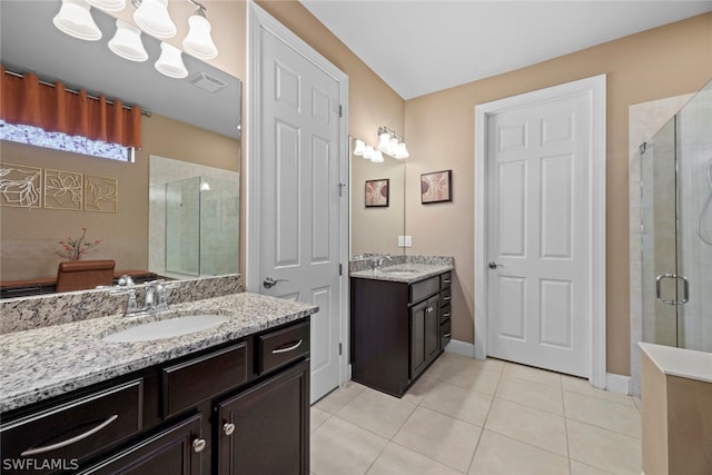 bathroom featuring a shower with door, double vanity, and tile floors