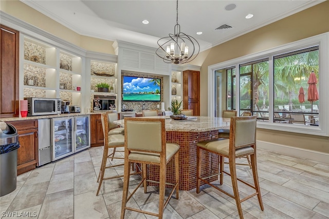 interior space with a notable chandelier, ornamental molding, and built in shelves