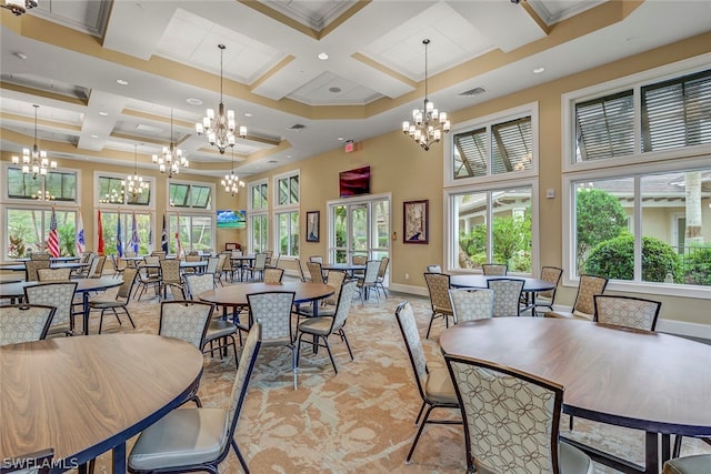 dining area featuring an inviting chandelier and coffered ceiling