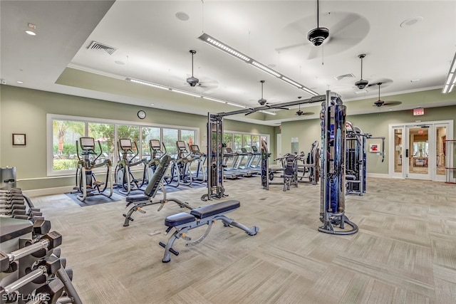 exercise room featuring french doors, light carpet, and ceiling fan