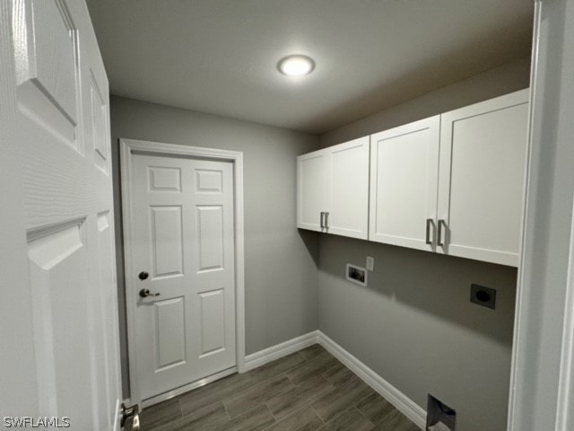 clothes washing area featuring cabinets, hookup for an electric dryer, and dark hardwood / wood-style floors