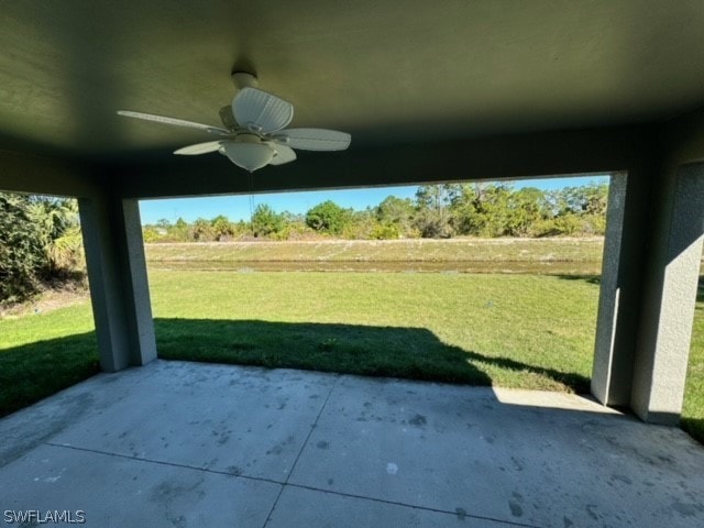 view of yard featuring ceiling fan and a patio