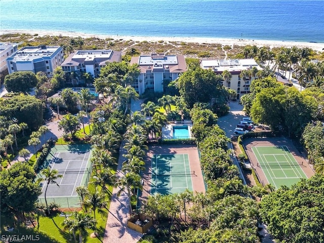 drone / aerial view featuring a water view and a beach view