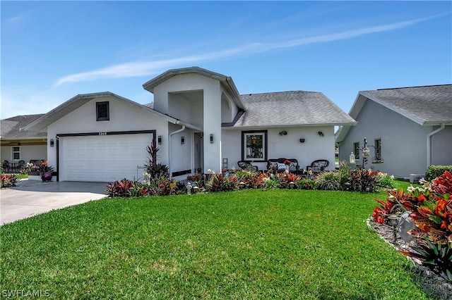 view of front of property featuring a garage and a front yard