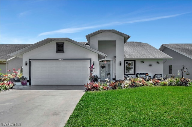 view of front of property featuring a garage and a front yard