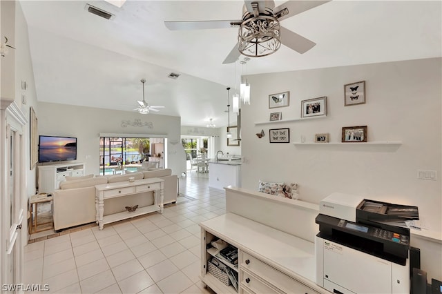 kitchen featuring ceiling fan, light tile patterned floors, and vaulted ceiling