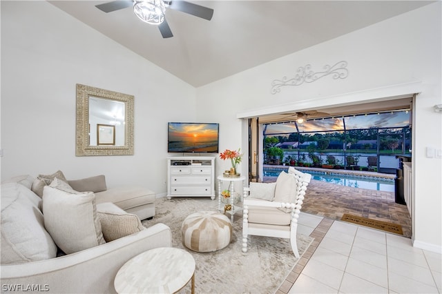 living room featuring ceiling fan, lofted ceiling, and light tile patterned floors