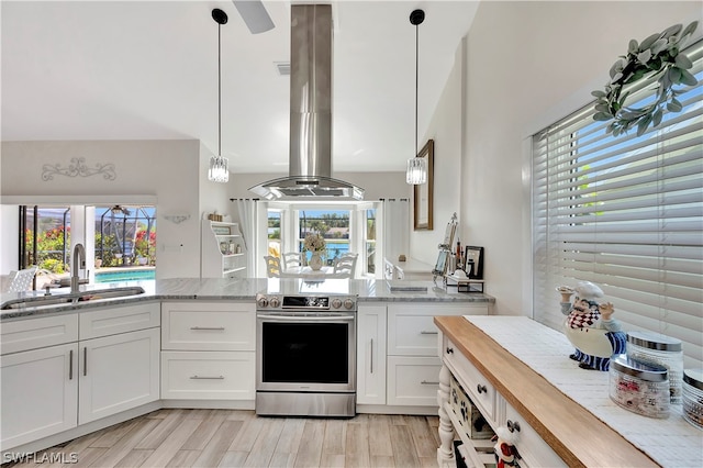 kitchen featuring island range hood, sink, pendant lighting, electric range, and white cabinets