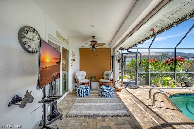 view of patio featuring glass enclosure and ceiling fan